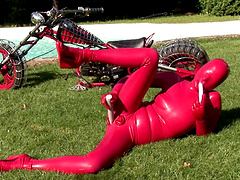 Lovely Sandy K wearing latex fingering her pussy outdoors