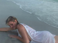 Incredible blonde with small tits and tattoo showcasing her nice ass in enticing beach shoot