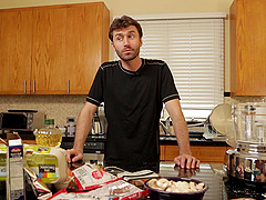 Handsome guy enjoys while cooking nice dinner for his family