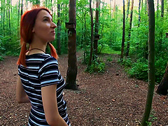 Redhead slut Elin gets down on her knees to suck a dick outdoors