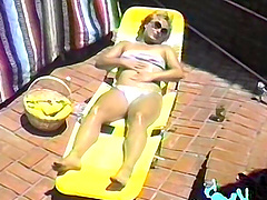 Blonde bombshell seduces in skirt and glasses for solo show