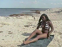 Beautiful long-haired brunette gets some beach action