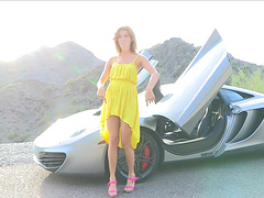 Naughty solo girl poses on a McLaren naked in pink high heels