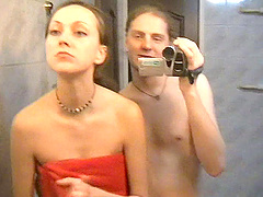Small boob brunette gets a bathroom handjob and blowjob from her man