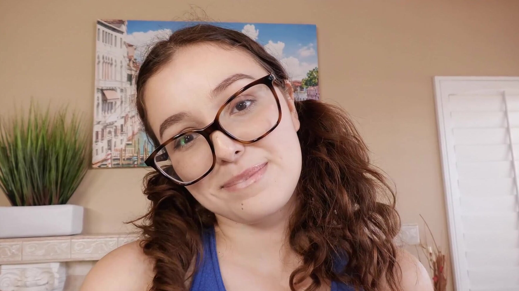 Brunette Leana Lovings seduces with her shaved pussy and glassed gaze