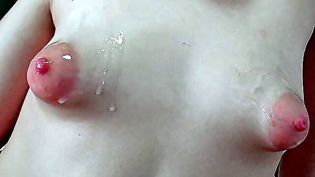 Cumming over a pair of puffy nippled boobs